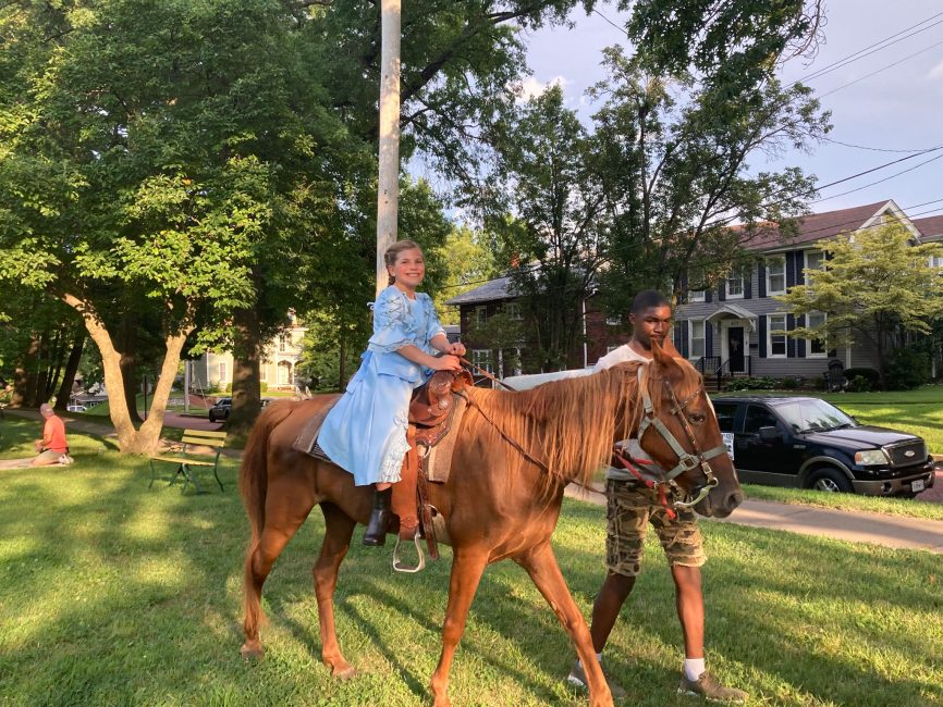 Lucy is always first in line for the pony rides.
